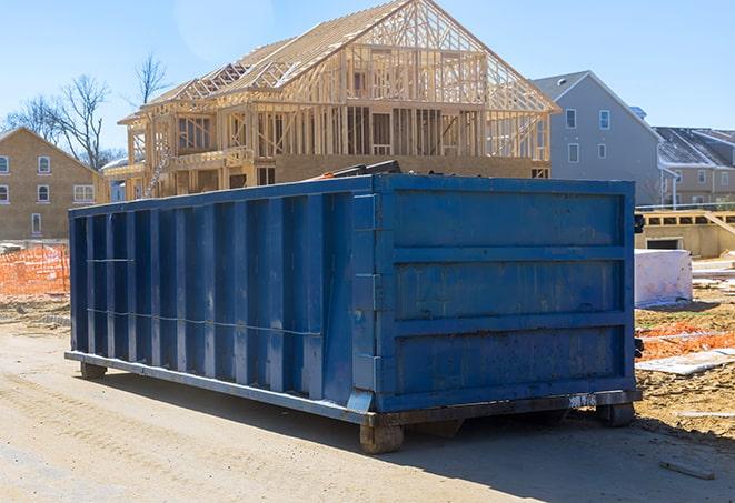 a residential dumpster full of trash sitting next to a home